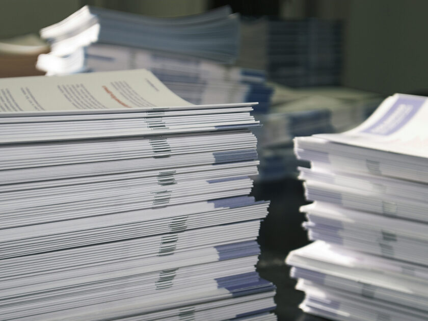 Piles,Of,Handout,Papers,Lying,On,A,Table.